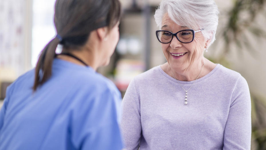 Happy Elderly Woman Talking with Healthcare Provider Happy Elderly Woman Talking with Healthcare Provider