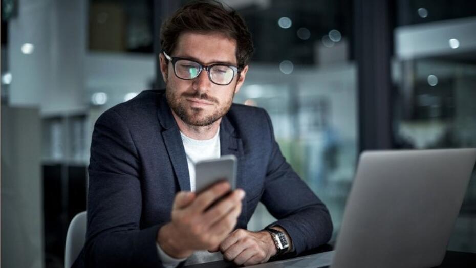 Man researching on his cell phone Man researching on his cell phone