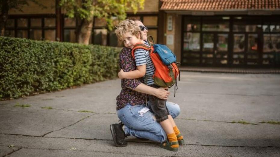 Schoolboy hugging mom small Schoolboy hugging mom small