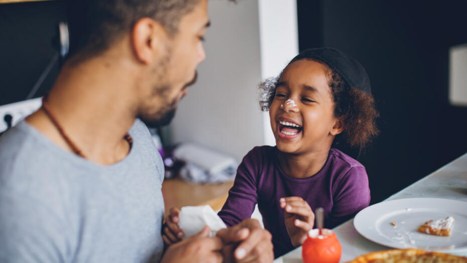 Father and son eating laughing Father and son eating laughing