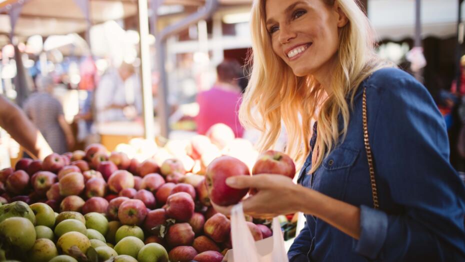 Smiling woman shopping for apples Smiling woman shopping for apples