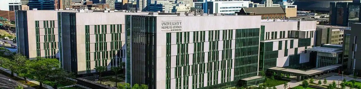 An aerial perspective of the multi-building University Medical Center complex, surrounded by trees and urban landscape.
