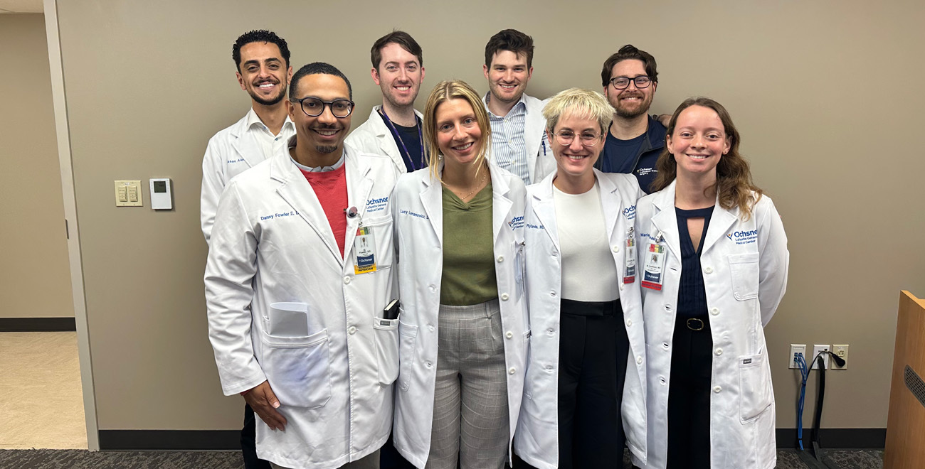 Ochsner Lafayette General Medical Center general surgery residents and physicians posing together in an office setting.