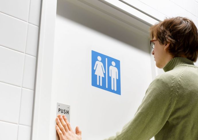 Man walking into unisex toilet