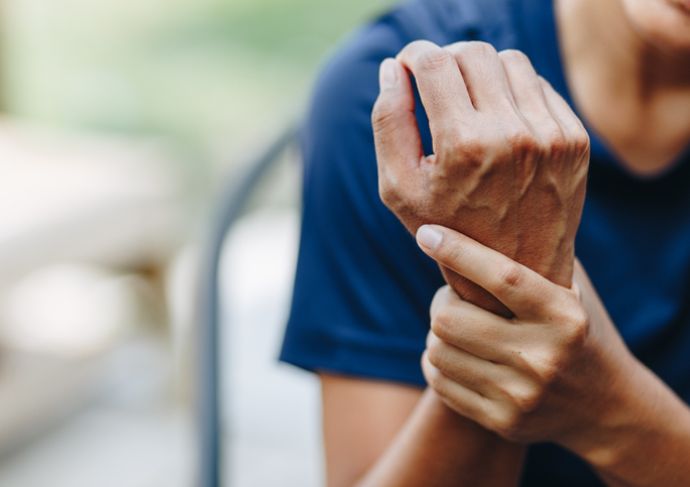 woman holding sprained wrist