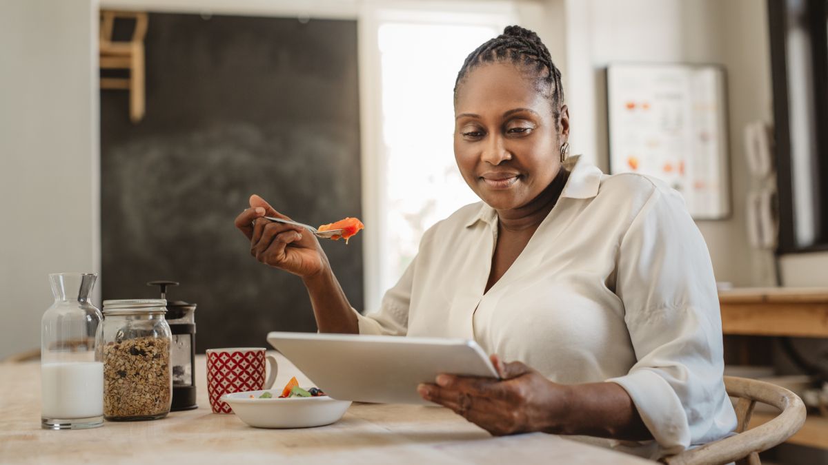 Woman eating in kitchen