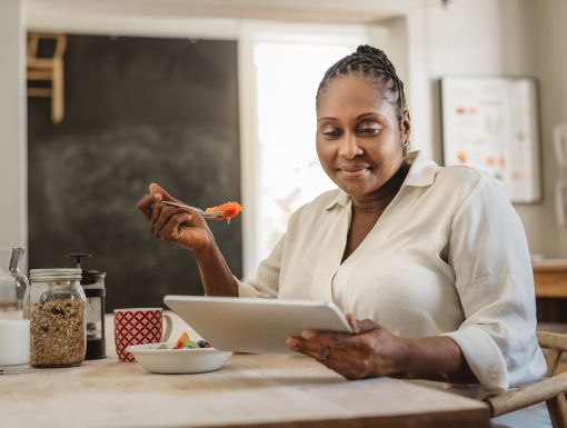 Woman eating in kitchen