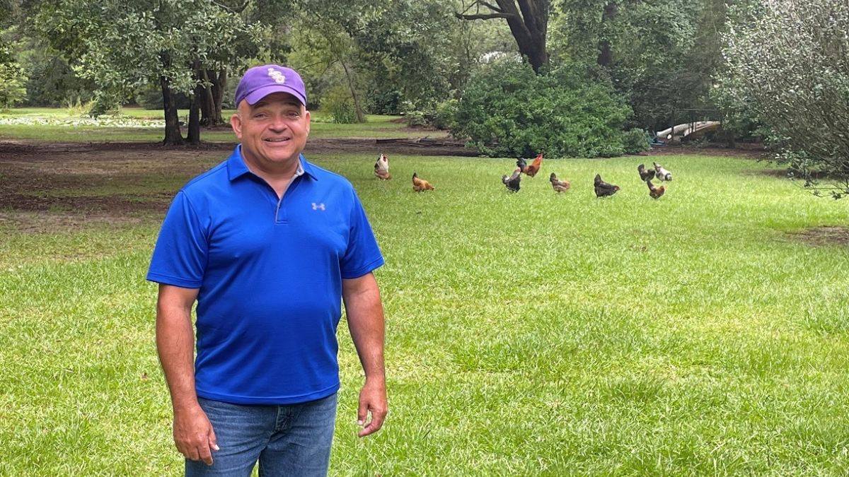 Allen William outside in park with ducks in background