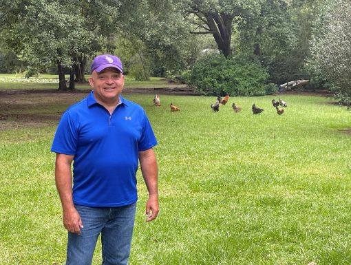 Allen William outside in park with ducks in background