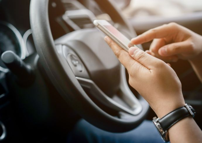 Person looking at phone in car