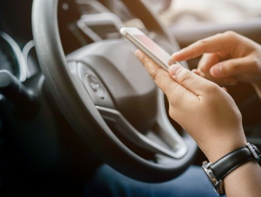 Person looking at phone in car