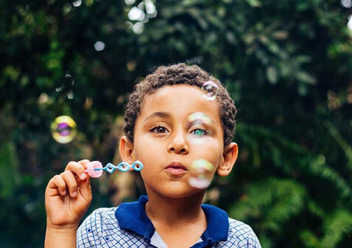 Boy blowing bubbles 2