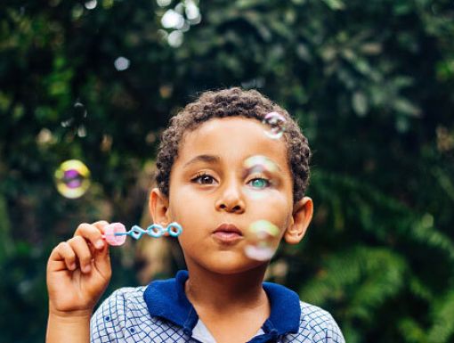 Boy blowing bubbles 2