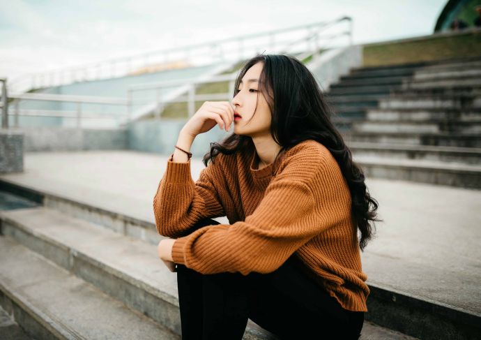 Young woman sitting outside on steps