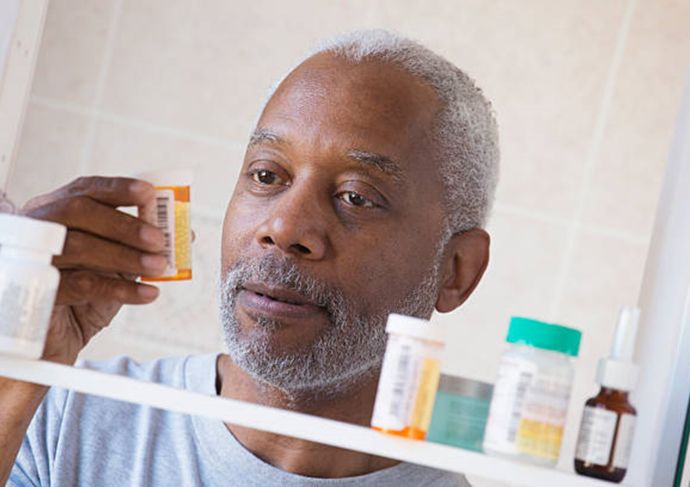 Elderly man reading a prescription label