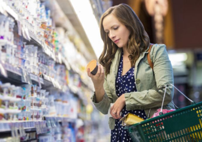 Woman reading yogurt label