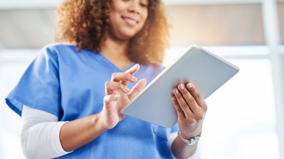 Woman accessing medical records on a tablet.