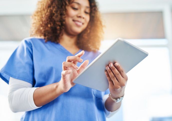 Woman accessing medical records on a tablet.