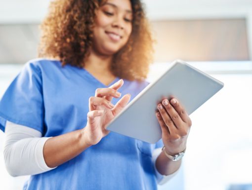 Woman accessing medical records on a tablet.
