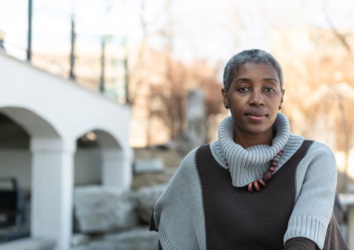 Woman sitting outside a building
