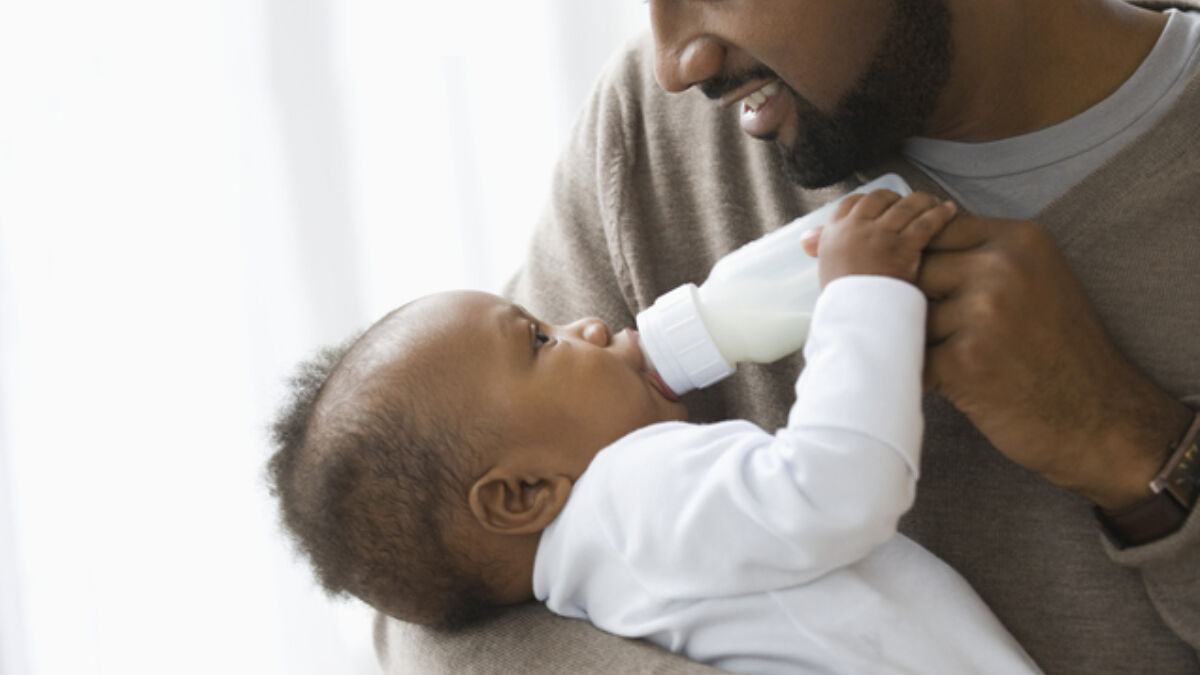 Dad feeding baby