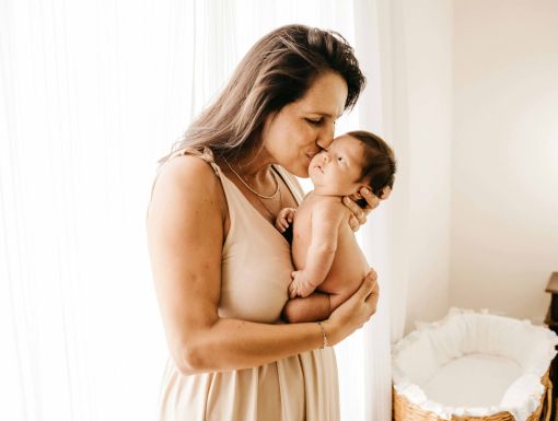 Woman who wants a tummy tuck holding newborn