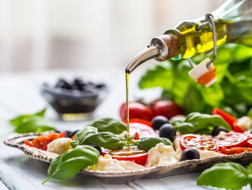 Pouring olive oil on salad