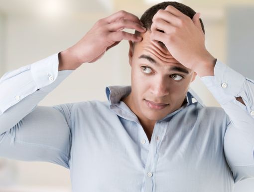 Man checking his hairline