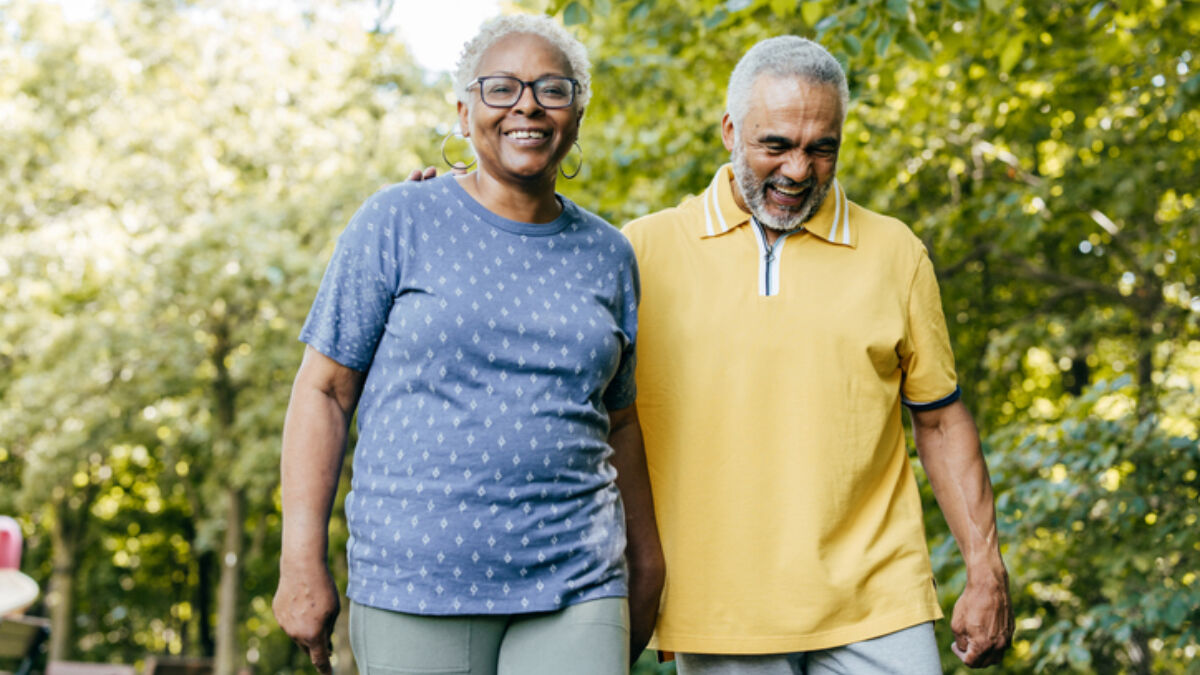 A man and woman walking outside together on a sunny day