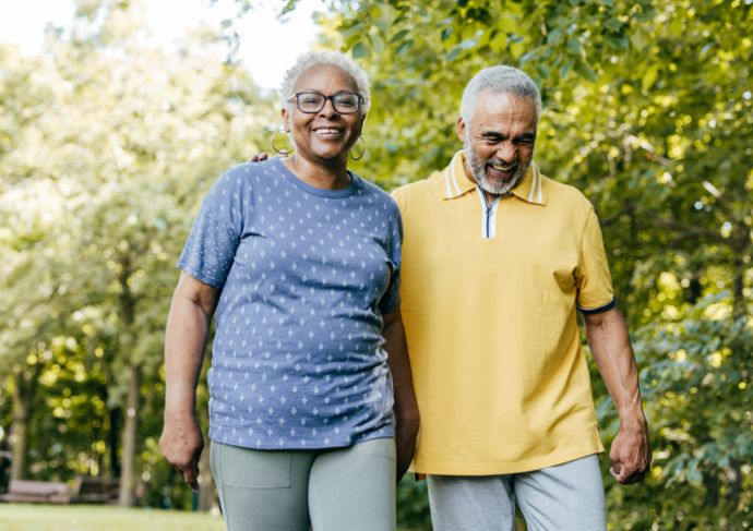 A man and woman walking outside together on a sunny day