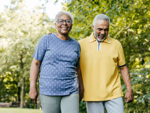 A man and woman walking outside together on a sunny day