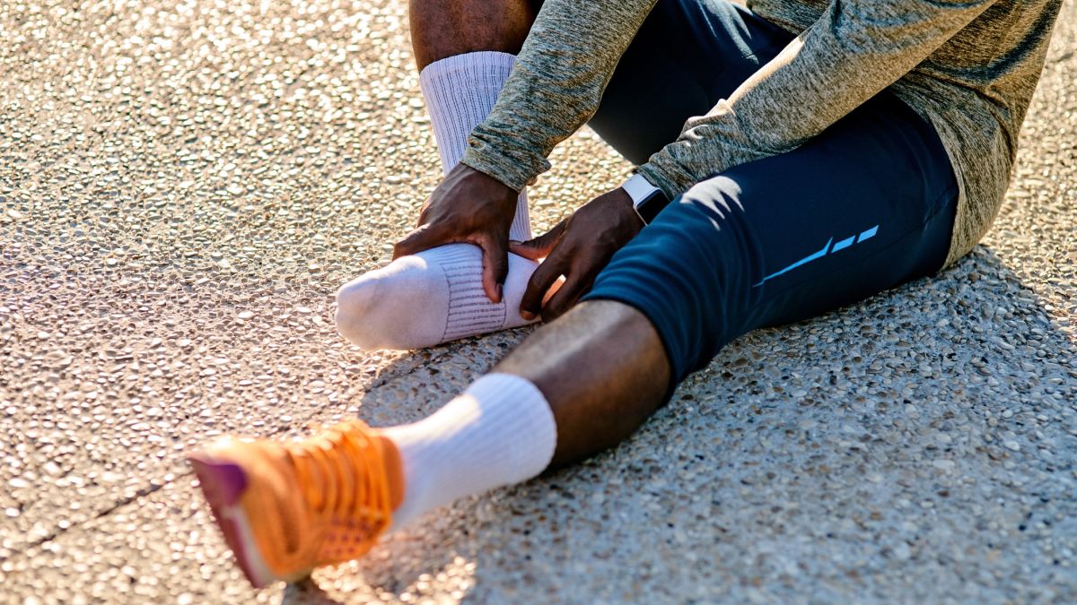 person holding heel of foot