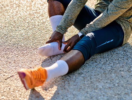 person holding heel of foot