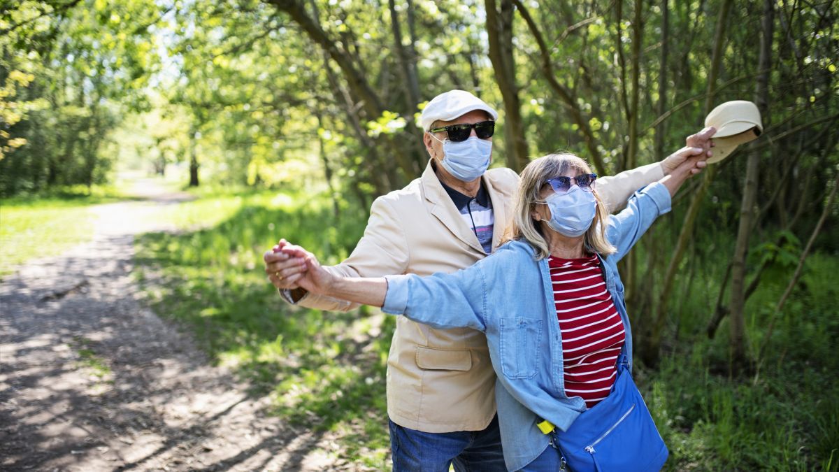 Older couple outdoors with mask on