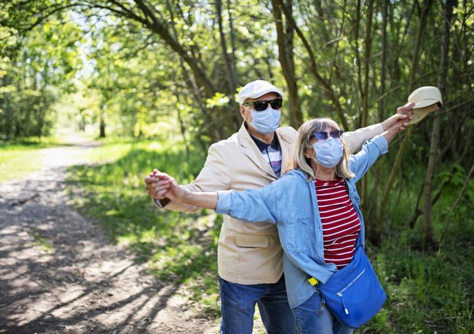 Older couple outdoors with mask on
