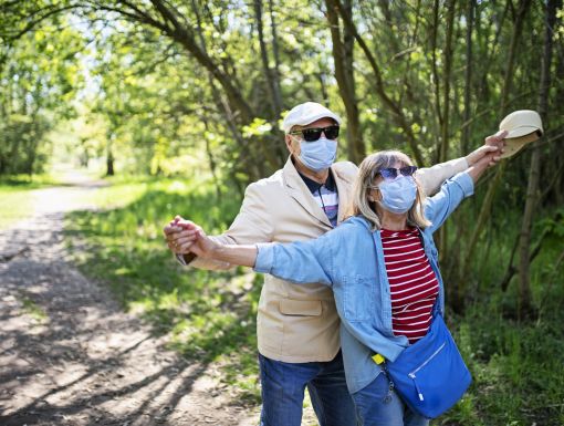 Older couple outdoors with mask on