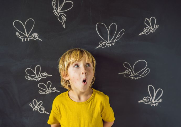 Little boy surrounded by mosquitoes