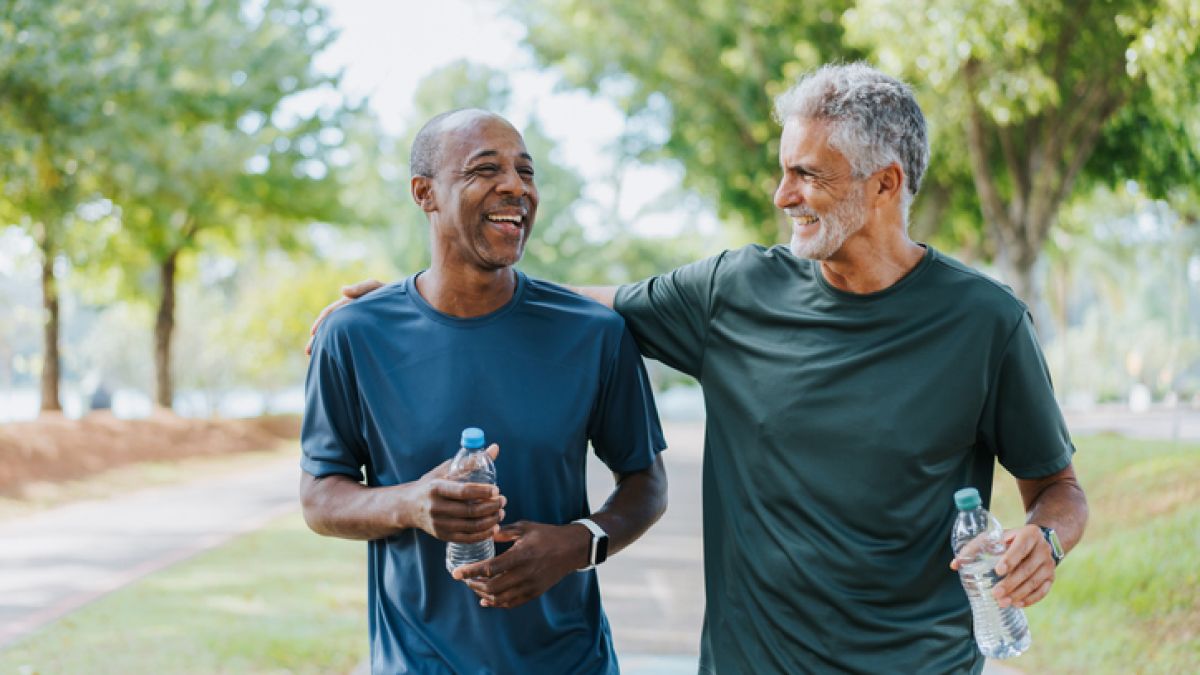 Two older friends walking in the park