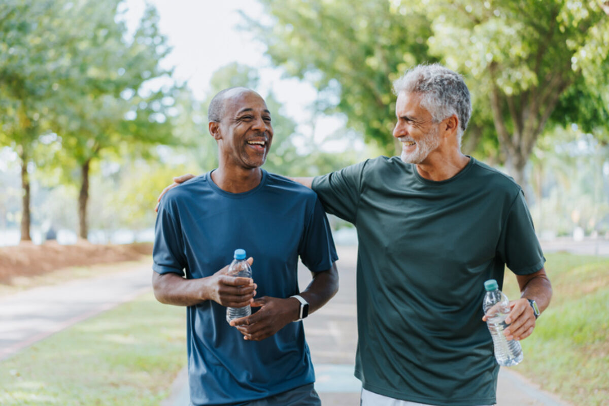 Two older friends walking in the park