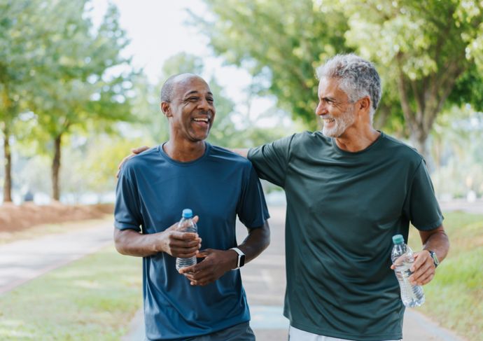 Two older friends walking in the park