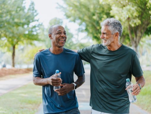 Two older friends walking in the park