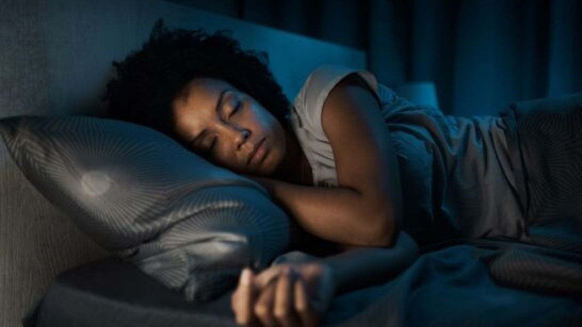 A woman with anxiety sleeping in her bed
