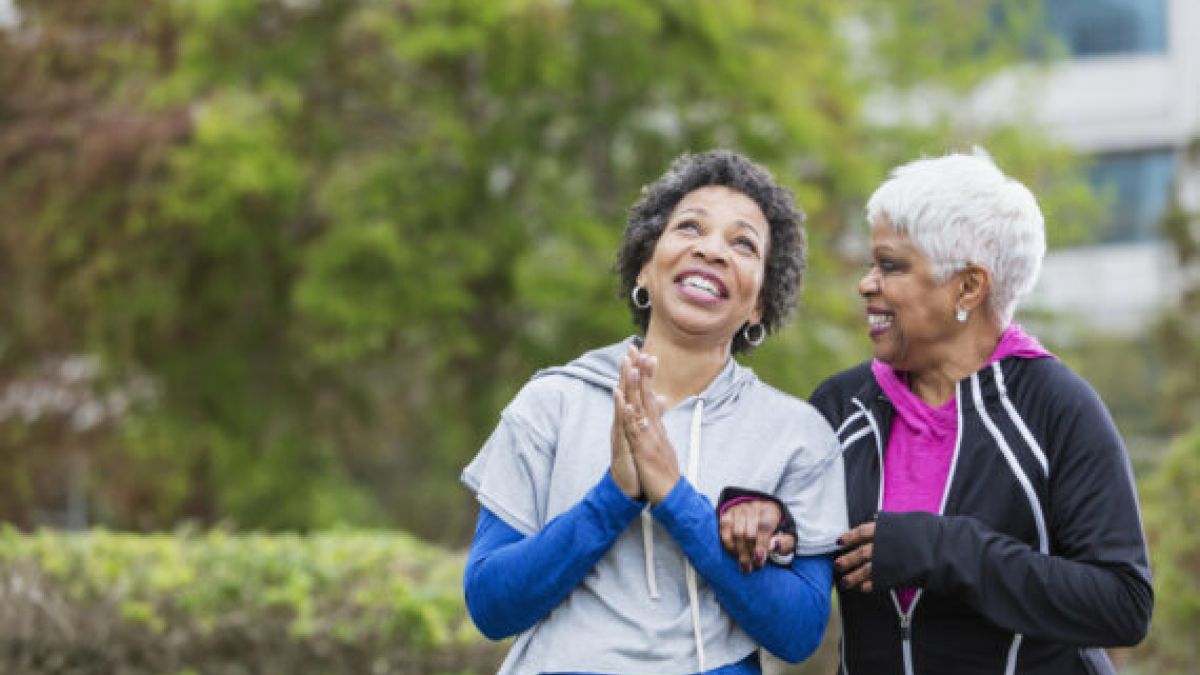 Older women walking outside, smiling