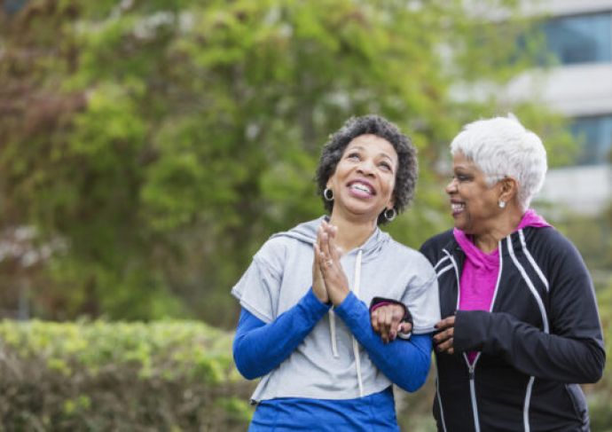 Older women walking outside, smiling