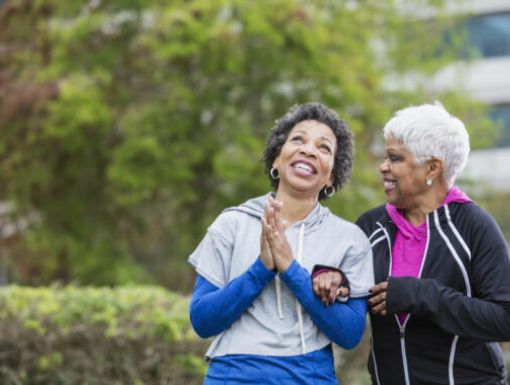Older women walking outside, smiling