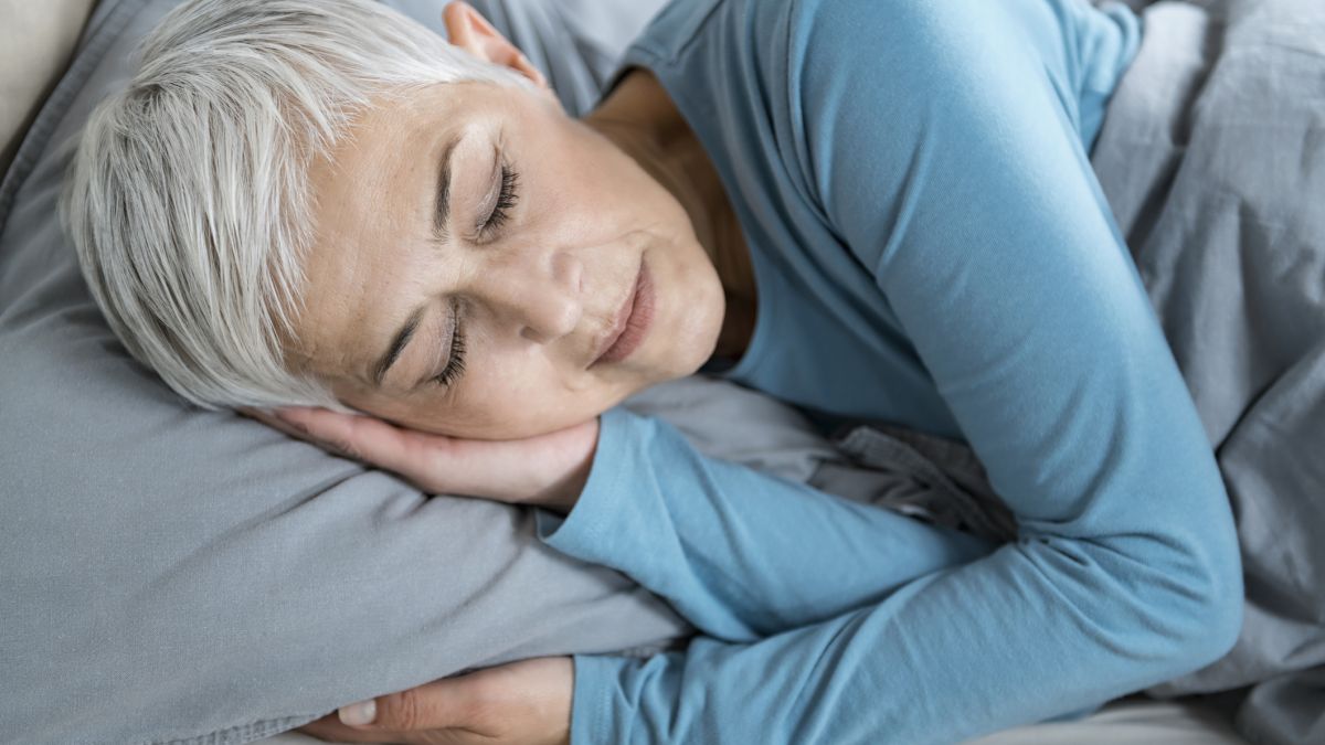 Older woman sleeping in bed