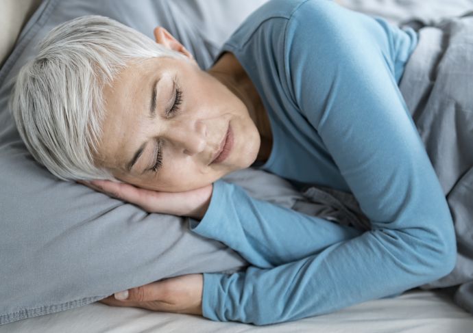 Older woman sleeping in bed