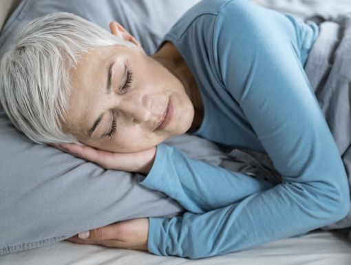 Older woman sleeping in bed