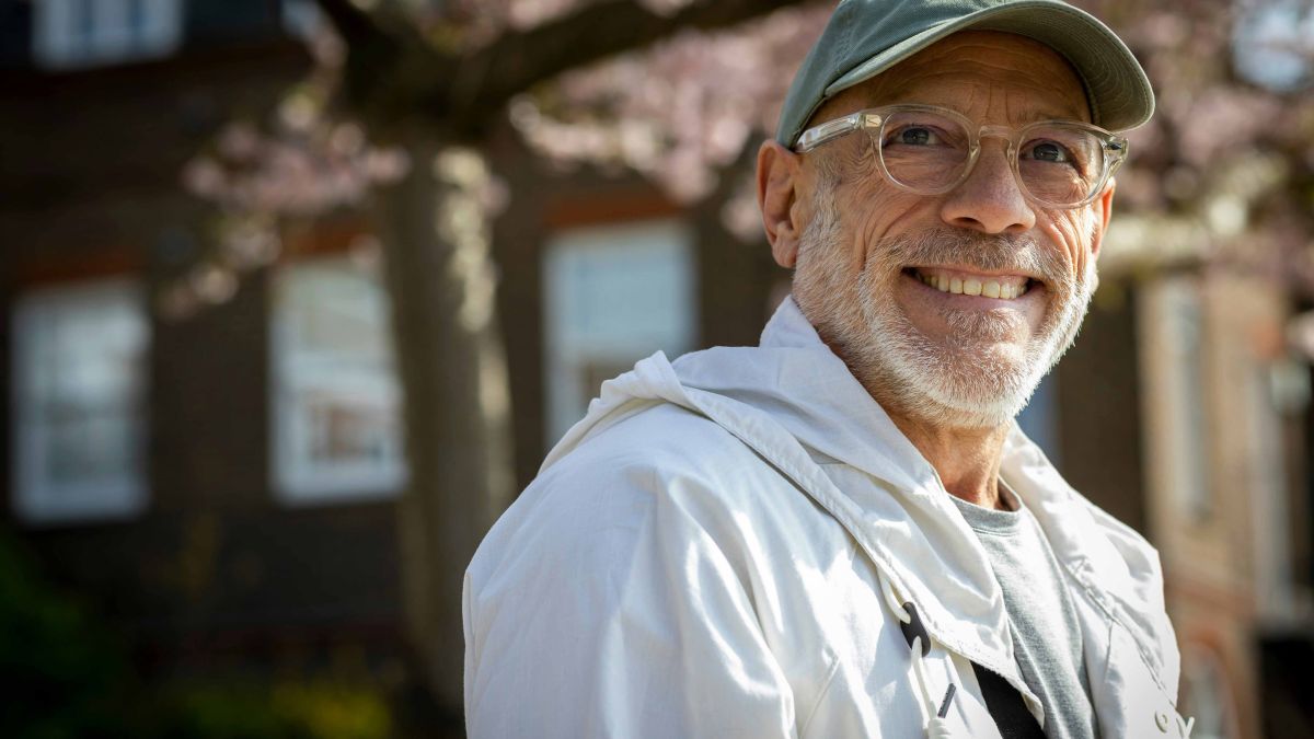 Older man wearing glasses and ball cap