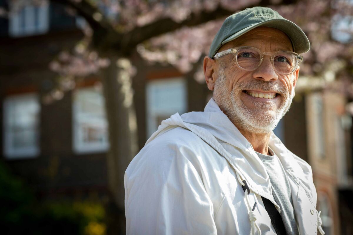 Older man wearing glasses and ball cap